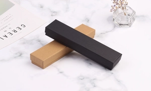Rectangular kraft and black jewelry boxes for necklaces on a marble background