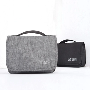 Hanging travel toiletry bags in grey and black fabric with handle and folding design