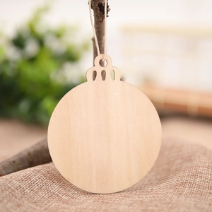 Rustic wooden Christmas ornament hanging on a branch with natural wood grain texture