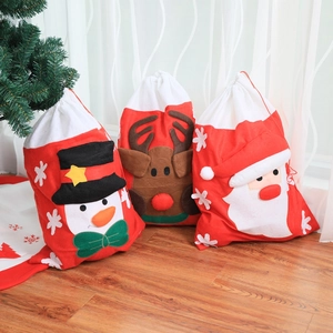 Three Christmas non-woven drawstring gift bags featuring Santa, Reindeer and Snowman patterns