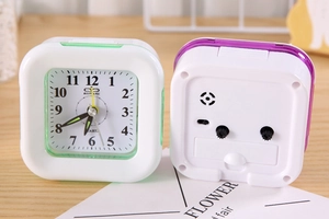 Detailed front and back view of a square plastic desk clock with adjustment knobs