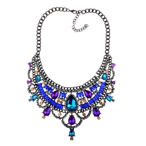 Detail of multilayer choker with blue crystals and black chain in gothic style