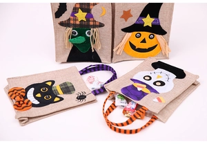 Close-up of four Halloween linen gift bags with pumpkin, witch, and cat felt appliques