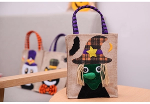 Detailed view of burlap Halloween candy bag featuring a 3D witch with striped handles