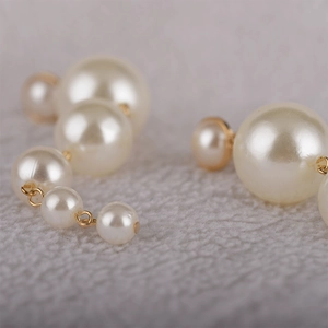 Macro shot of elegant cream-white pearls cascading with gold metal link details