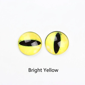 Macro detail of bright yellow glass cabochon with realistic cat eye pupil for DIY crafts