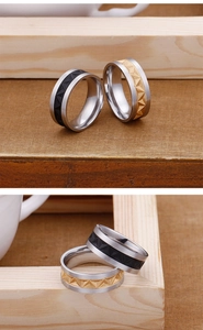 Close-up of geometric embossed titanium steel rings with silver gold and black finishes