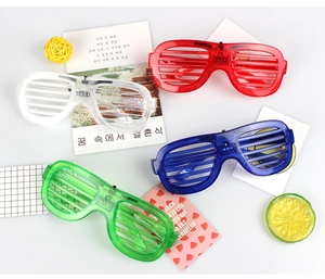 Set of four LED shutter glasses in red, clear, blue, and green for party activities
