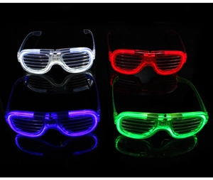 Four LED shutter glasses glowing in white, red, blue, and green on a dark surface