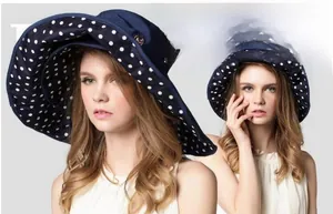 Detail of navy sun hat with wide brim featuring white polka dot lining for UV protection