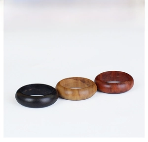 Three classic wooden rings in black, natural, and mahogany finishes on a white background