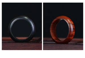Detail showing natural wood grain texture on dark ebony and redwood minimalist rings