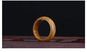 Macro detail of hand-polished rosewood ring showing natural wood grain and textures