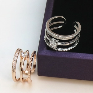 Detail of rose gold and silver triple-layered rings with diamonds in a velvet box