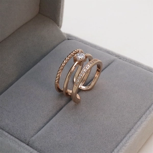 Macro shot of rose gold triple-layered open ring with rhinestones in a velvet box