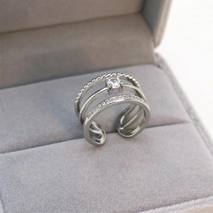 Macro view of adjustable silver triple layer ring with sparkling round zircon stone