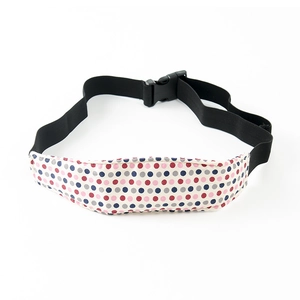 Close-up of baby car seat head support strap with colorful polka dots and buckle