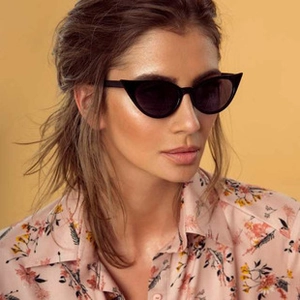 Detailed view of trendy cat eye sunglasses featuring thick black frames and dark lenses