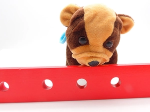 Close-up of plush puppy pencil case with realistic fur texture and wooden detail