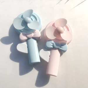 Close-up of pink and blue lollipop-shaped handheld fans with cute bow details
