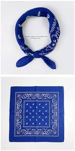 Detail of blue paisley cotton scarf showing the square fold and elegant knotted styling