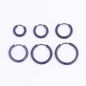 Set of 6 black stainless steel hoop earrings in three sizes on white background