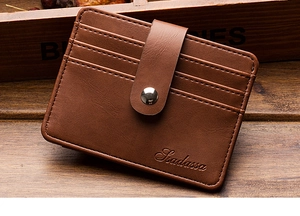 Close-up of brown leather card holder featuring neat stitching and a secure snap button