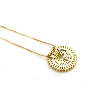 Detail view of gold circular hollow cross pendant with cubic zirconia on square chain