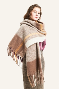 Close-up of thick tassels and plaid pattern on soft brown mohair-style oversized scarf