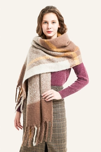 Detail of soft brown plaid scarf featuring thick tassels and a chunky mohair-like texture