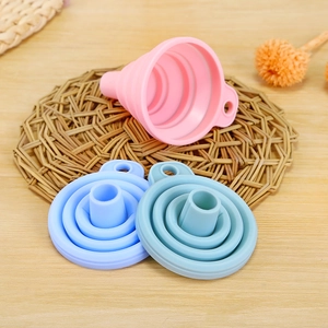 Set of three colorful silicone collapsible kitchen funnels in pink, blue and green colors
