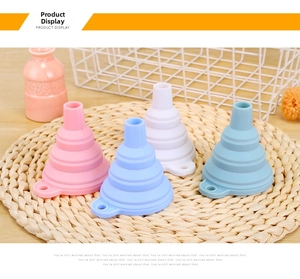 Detail view of four foldable silicone kitchen funnels in pink, purple, and blue colors