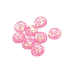 Detailed view of 12mm pink synthetic opal stones with iridescent foil flakes for DIY jewelry
