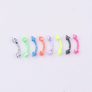 Detail view of eight colorful paint-splatter curved barbell eyebrow rings with spike ends