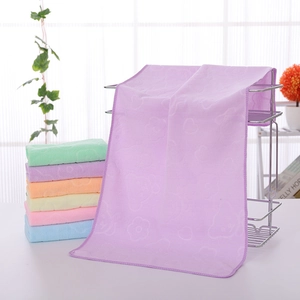Detail of embossed bear microfiber towels in various colors hanging on a rack