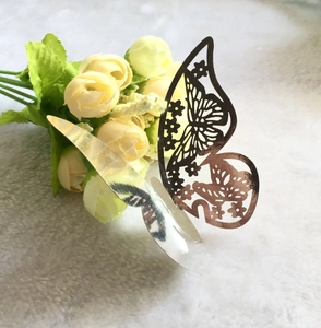 Macro detail of rose gold 3d butterfly place card with laser-cut lace and metallic finish