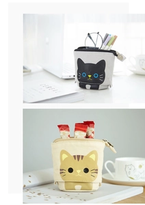 Detailed view of standing canvas pencil cases featuring cute grey and beige cat designs
