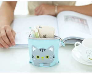 Macro detail of blue canvas telescopic pencil case with cute grey tabby cat face design