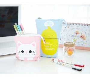 Standing telescopic canvas pencil cases with cat and chick patterns on a desk
