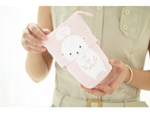 Pink canvas telescopic pencil case with cute sheep pattern held by a model