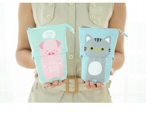 Detail of retractable canvas pencil case with cute cat and pig cartoon patterns