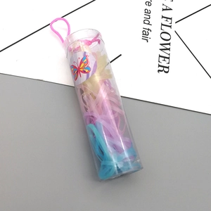 Macro shot of colorful elastic hair bands in a portable cylindrical clear container