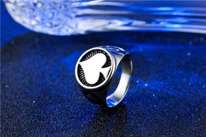 Macro detail of punk spade ace ring featuring brushed stainless steel and black enamel