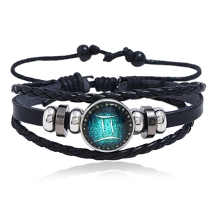 Detailed view of Gemini zodiac multilayer leather bracelet with glowing glass charm