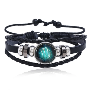 Detailed view of layered woven leather bracelet with luminous Virgo glass charm