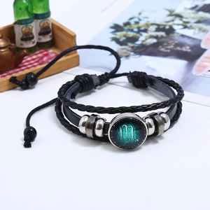 Macro shot of Scorpio zodiac sign glass pendant on multi-layer braided leather bracelet