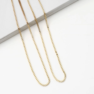 Close-up of three layered 18K gold-plated box chains for sunglasses and eyewear