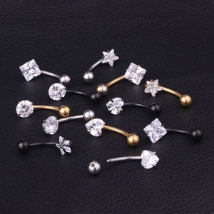 Macro shot of assorted stainless steel navel rings with cubic zirconia in star and heart shapes