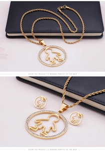 Detailed view of a gold-plated titanium jewelry set featuring round boy silhouette pendants