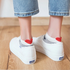 Japanese style white canvas platform shoes with red heart ankle socks on wooden floor